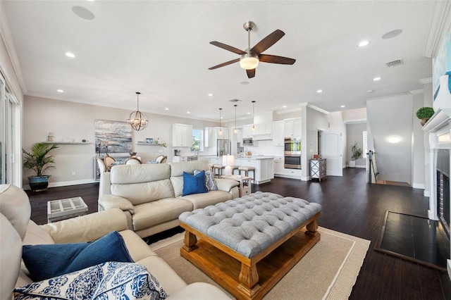 7115 Bay St, St Pete Beach, FL 33706 - living area featuring a ceiling fan, recessed lighting, crown molding, dark wood-type flooring, and baseboards