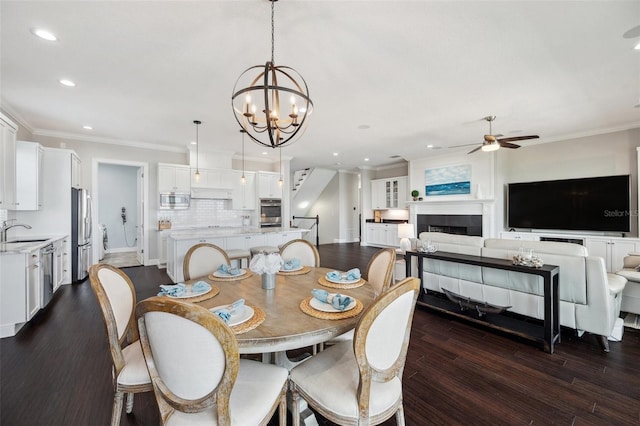 7115 Bay St, St Pete Beach, FL 33706 - dining space featuring ceiling fan, recessed lighting, dark wood-style flooring, a chandelier, and crown molding