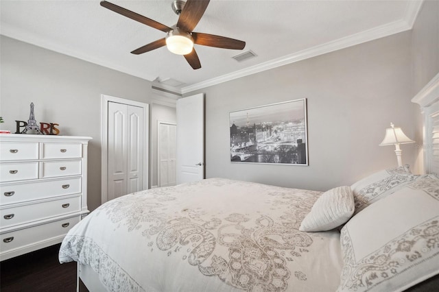 7115 Bay St, St Pete Beach, FL 33706 - bedroom with two closets, ornamental molding, ceiling fan, and dark wood-type flooring