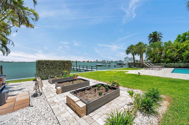 7115 Bay St, St Pete Beach, FL 33706 - view of patio featuring a water view and a vegetable garden