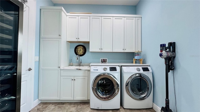 7115 Bay St, St Pete Beach, FL 33706 - laundry area featuring cabinet space, washer and clothes dryer, and baseboards