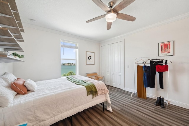 7115 Bay St, St Pete Beach, FL 33706 - bedroom with wood finished floors, ornamental molding, a closet, ceiling fan, and baseboards
