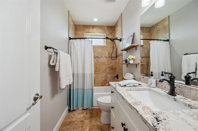 7115 Bay St, St Pete Beach, FL 33706 - bathroom with vanity, toilet, shower / bath combo with shower curtain, and baseboards