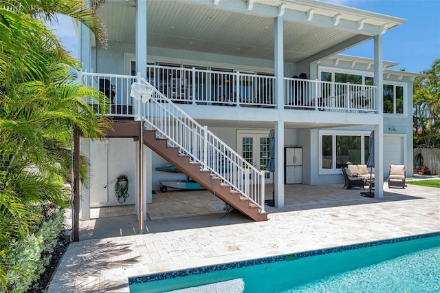7115 Bay St, St Pete Beach, FL 33706 - rear view of house with a patio, an outdoor pool, and stucco siding