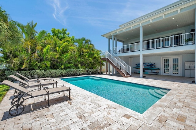 7115 Bay St, St Pete Beach, FL 33706 - outdoor pool featuring french doors, a patio area, and stairs