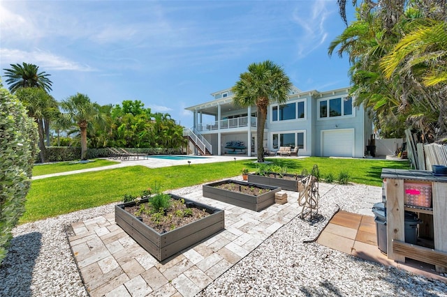 7115 Bay St, St Pete Beach, FL 33706 - view of patio / terrace with stairs, a garden, and an outdoor pool