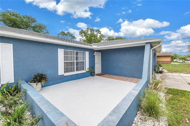 2270 Amherst Ave, Spring Hill, FL 34609 - view of exterior entry with a patio and stucco siding