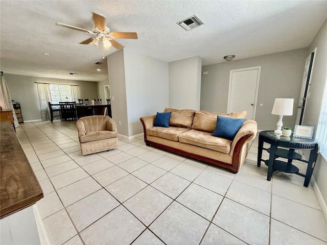 2270 Amherst Ave, Spring Hill, FL 34609 - living area featuring light tile patterned flooring, ceiling fan, baseboards, and a textured ceiling