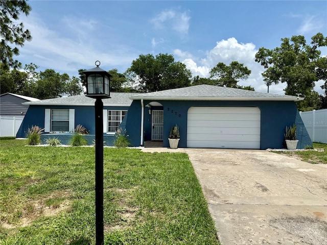 2270 Amherst Ave, Spring Hill, FL 34609 - view of front of house featuring stucco siding, driveway, and an attached garage