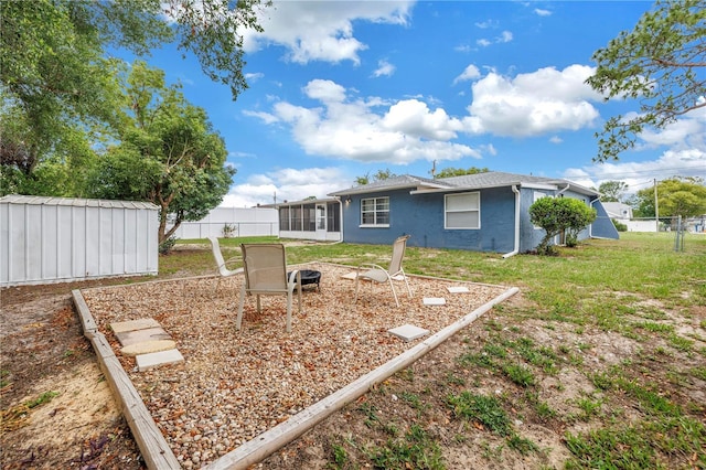 2270 Amherst Ave, Spring Hill, FL 34609 - view of yard with a storage unit, an outdoor fire pit, an outdoor structure, and a sunroom