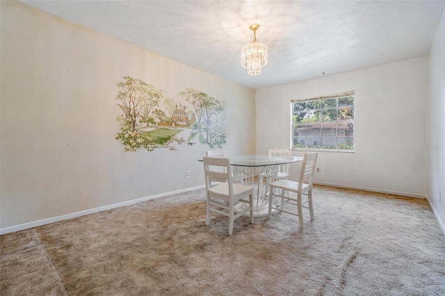 dining room with a chandelier, carpet flooring, and baseboards