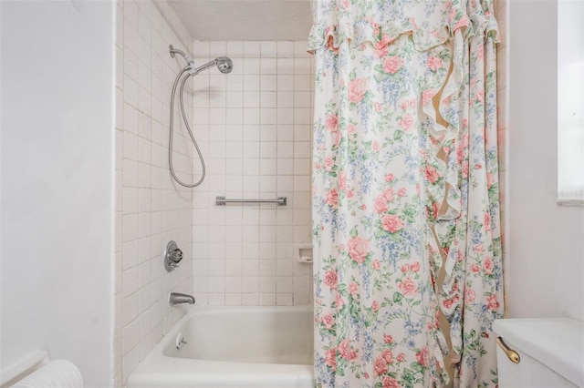 bathroom with shower / tub combo and toilet