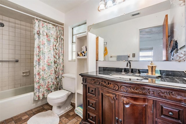 bathroom featuring toilet, shower / bath combo, and vanity