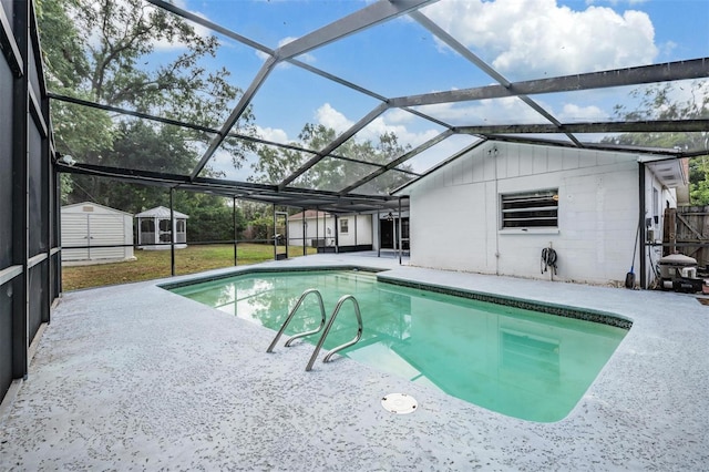 outdoor pool with a storage unit, a patio, an outdoor structure, and a lawn