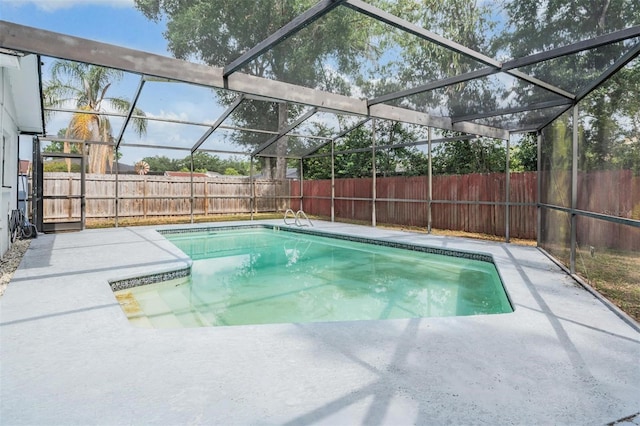 view of pool with a patio, a fenced backyard, and a lanai