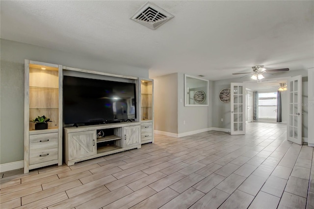 9120 Lunar Ln, Port Richey, FL 34668 - unfurnished living room with french doors, a ceiling fan, baseboards, and light wood-type flooring