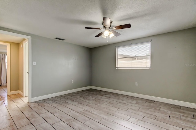 9120 Lunar Ln, Port Richey, FL 34668 - unfurnished room featuring ceiling fan, a textured ceiling, and baseboards