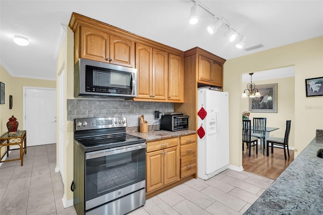 700 Bowsprit Pl, Palm Harbor, FL 34685 - kitchen featuring appliances with stainless steel finishes, tasteful backsplash, light stone countertops, a chandelier, and crown molding