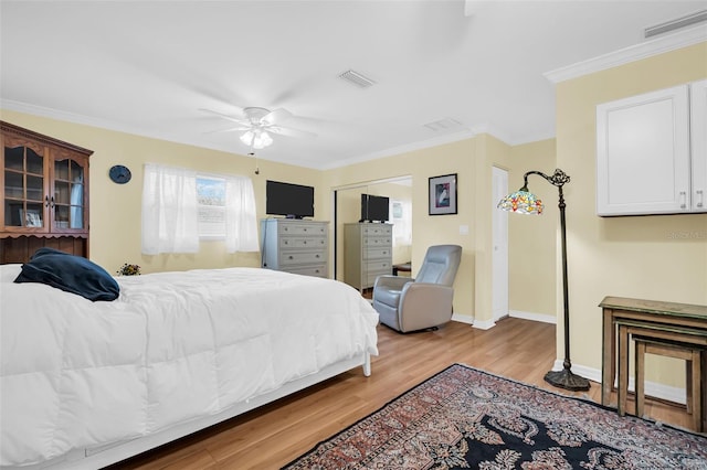 700 Bowsprit Pl, Palm Harbor, FL 34685 - bedroom featuring light wood finished floors, ornamental molding, baseboards, a ceiling fan, and a closet