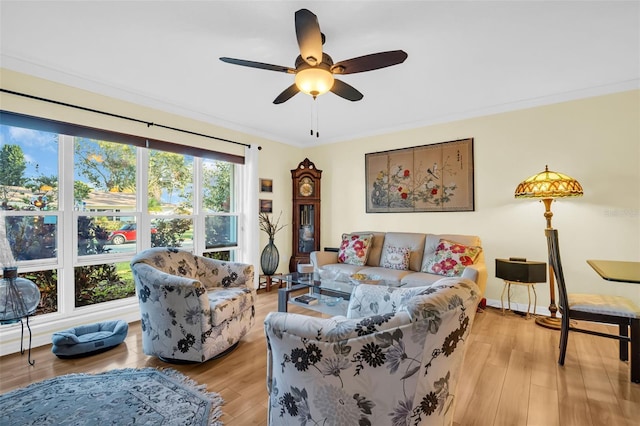 700 Bowsprit Pl, Palm Harbor, FL 34685 - living area featuring a ceiling fan, light wood finished floors, and ornamental molding