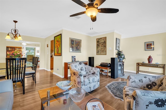 700 Bowsprit Pl, Palm Harbor, FL 34685 - living room with ornamental molding, light wood-style flooring, a ceiling fan, baseboards, and a chandelier