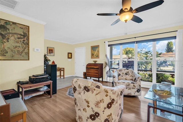 700 Bowsprit Pl, Palm Harbor, FL 34685 - living area with ornamental molding, wood finished floors, a ceiling fan, and baseboards
