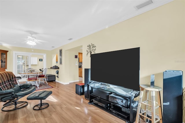 700 Bowsprit Pl, Palm Harbor, FL 34685 - living area with light wood-style flooring, ceiling fan, baseboards, and ornamental molding