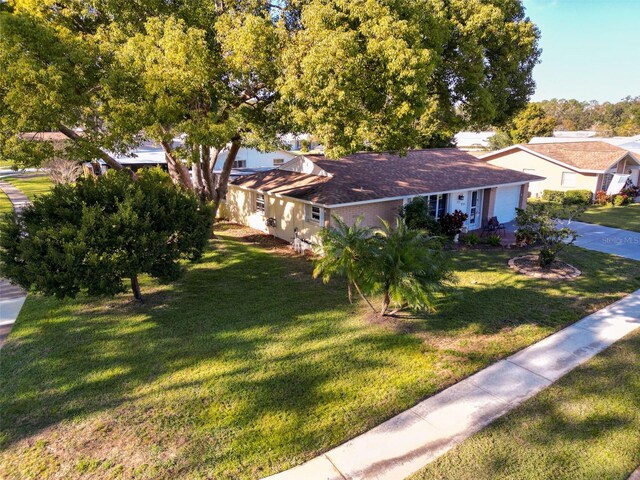 700 Bowsprit Pl, Palm Harbor, FL 34685 - view of front facade featuring a front yard, concrete driveway, and an attached garage