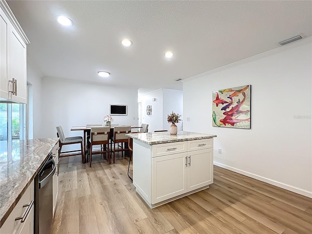 kitchen featuring light wood-type flooring, recessed lighting, white cabinets, a kitchen island, and dishwasher