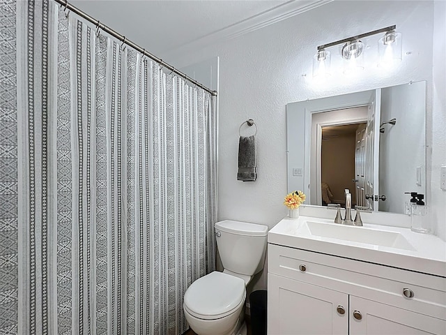 bathroom featuring toilet, vanity, a textured wall, and curtained shower