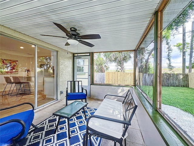 sunroom / solarium with a ceiling fan