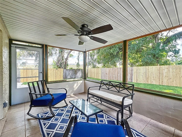 sunroom / solarium featuring healthy amount of natural light and ceiling fan