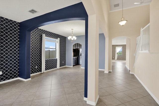 10106 Count Fleet Dr, Ruskin, FL 33575 - entryway featuring arched walkways, light tile patterned floors, and an accent wall