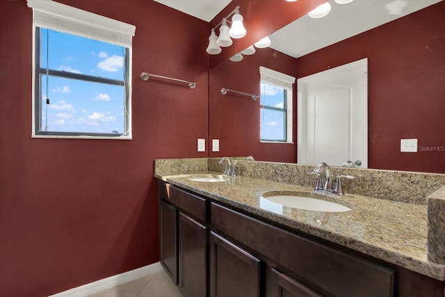 10106 Count Fleet Dr, Ruskin, FL 33575 - full bathroom featuring double vanity, baseboards, and tile patterned floors