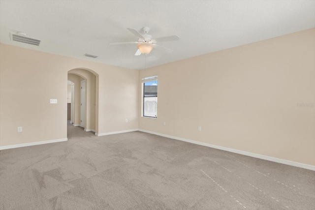10106 Count Fleet Dr, Ruskin, FL 33575 - carpeted empty room with arched walkways, ceiling fan, and baseboards