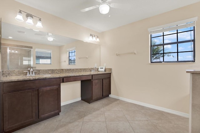 10106 Count Fleet Dr, Ruskin, FL 33575 - bathroom featuring a ceiling fan, a stall shower, baseboards, double vanity, and tile patterned floors