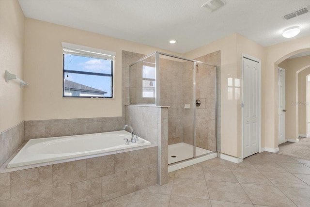 10106 Count Fleet Dr, Ruskin, FL 33575 - full bathroom with a stall shower, a garden tub, and tile patterned floors