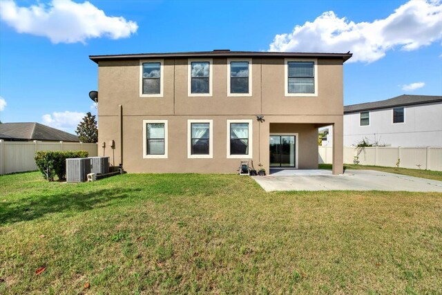 10106 Count Fleet Dr, Ruskin, FL 33575 - back of property with central air condition unit, a patio, and stucco siding