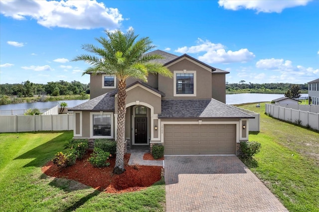 10106 Count Fleet Dr, Ruskin, FL 33575 - traditional home with stucco siding, a water view, decorative driveway, an attached garage, and roof with shingles