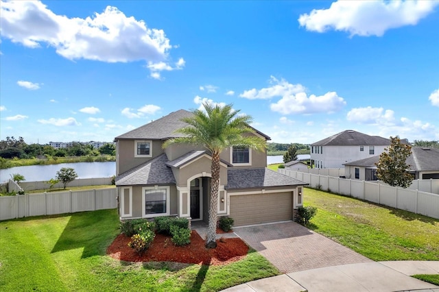 10106 Count Fleet Dr, Ruskin, FL 33575 - traditional-style house with stucco siding, decorative driveway, a water view, and a shingled roof