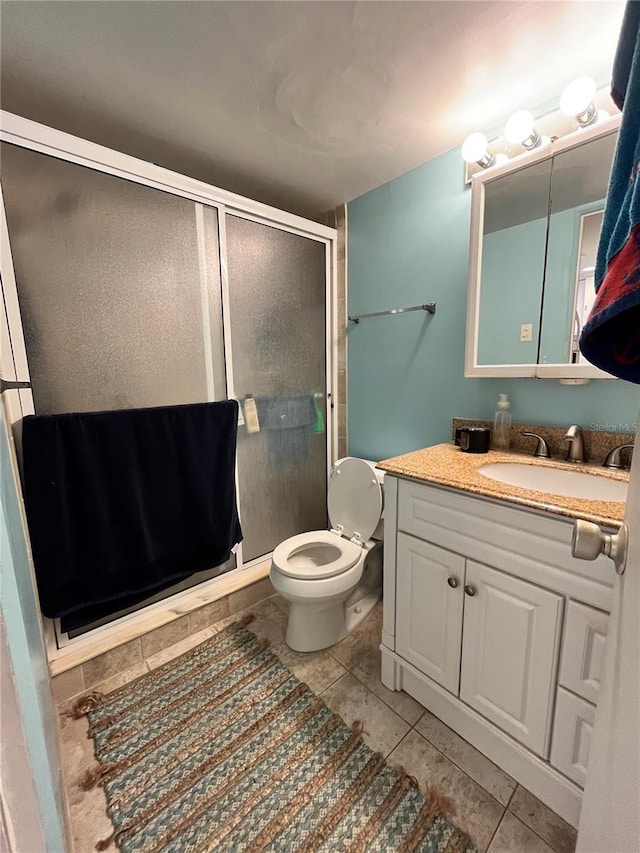 16400 Gulf Blvd Unit 307, North Redington Beach, FL 33708 - bathroom featuring tile patterned floors, a stall shower, vanity, and toilet