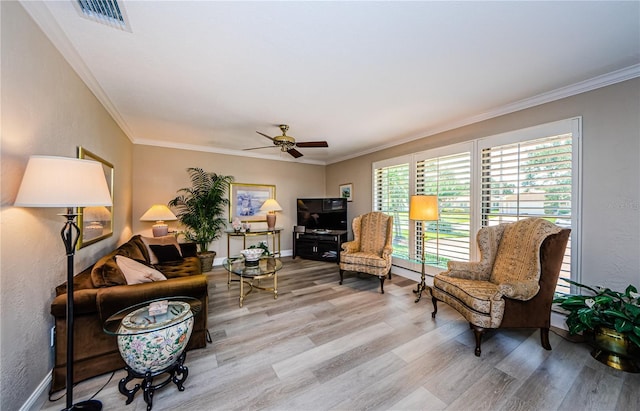 671 Tallahassee Dr NE, Saint Petersburg, FL 33702 - living area featuring wood finished floors, a ceiling fan, ornamental molding, baseboards, and a textured wall