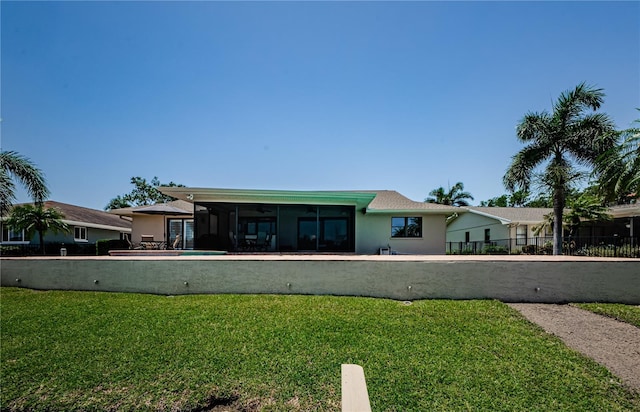 671 Tallahassee Dr NE, Saint Petersburg, FL 33702 - rear view of house featuring a sunroom and stucco siding