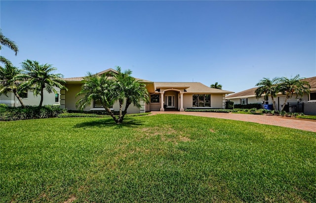 671 Tallahassee Dr NE, Saint Petersburg, FL 33702 - ranch-style home with decorative driveway, a front yard, and stucco siding