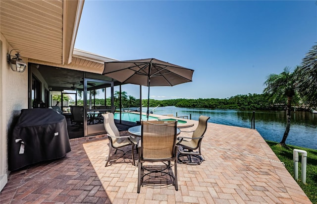671 Tallahassee Dr NE, Saint Petersburg, FL 33702 - view of patio / terrace with area for grilling, a water view, outdoor dining area, an infinity pool, and a ceiling fan