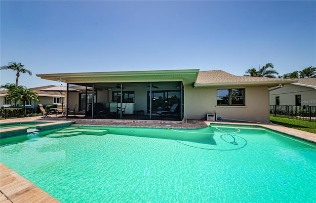 671 Tallahassee Dr NE, Saint Petersburg, FL 33702 - view of swimming pool with ceiling fan, fence, a pool with connected hot tub, a patio, and a sunroom