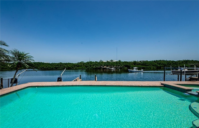 671 Tallahassee Dr NE, Saint Petersburg, FL 33702 - view of swimming pool featuring a dock, boat lift, a pool with connected hot tub, and a water view