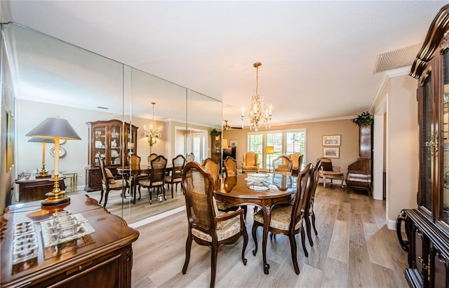 671 Tallahassee Dr NE, Saint Petersburg, FL 33702 - dining area featuring a chandelier, crown molding, and light wood-style floors
