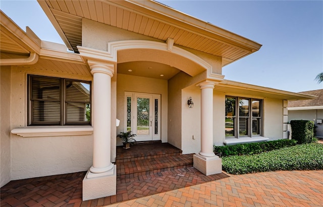 671 Tallahassee Dr NE, Saint Petersburg, FL 33702 - view of exterior entry with stucco siding and covered porch