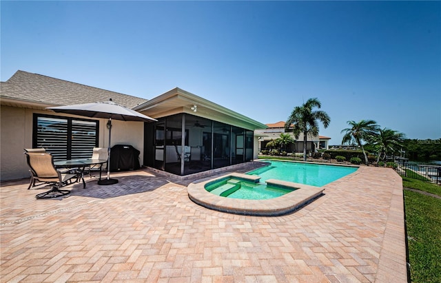 671 Tallahassee Dr NE, Saint Petersburg, FL 33702 - view of swimming pool featuring a sunroom, a patio, fence, a pool with connected hot tub, and grilling area